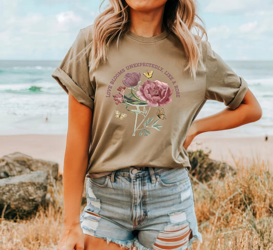 Comfy Love Blooms Unexpectedly Like A Rose T-shirt with Pink Lettering