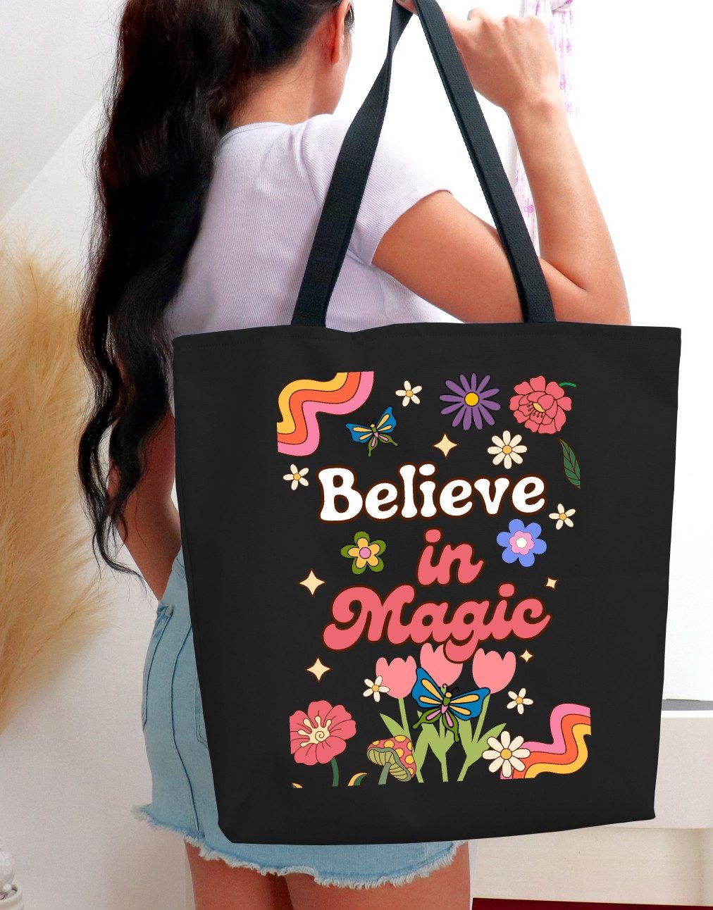 Brighten your day and your style with our high-quality cotton tote bag, featuring charming retro-style daisy flowers and an inspirational quote about believing in the magic of life!
