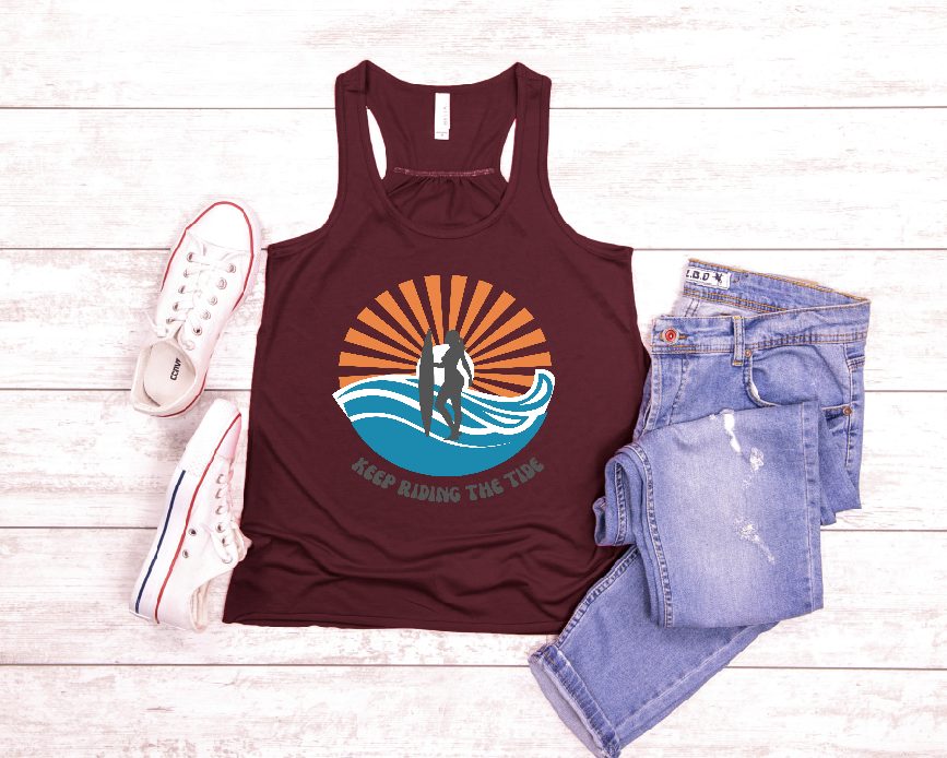 Hey, surf-loving ladies! Elevate your beach style with our fun and fabulous flowy tank, designed just for you. Featuring a cool graphic of a girl riding the waves and a catchy phrase, this tank is perfect for showing off your passion for surfing.